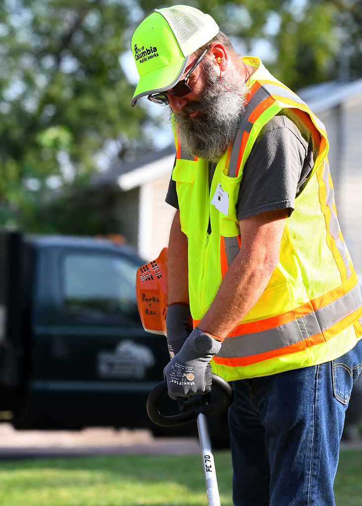 Gary Kinnecom weed whacks on Friday during Operation Clean Neighborhoods